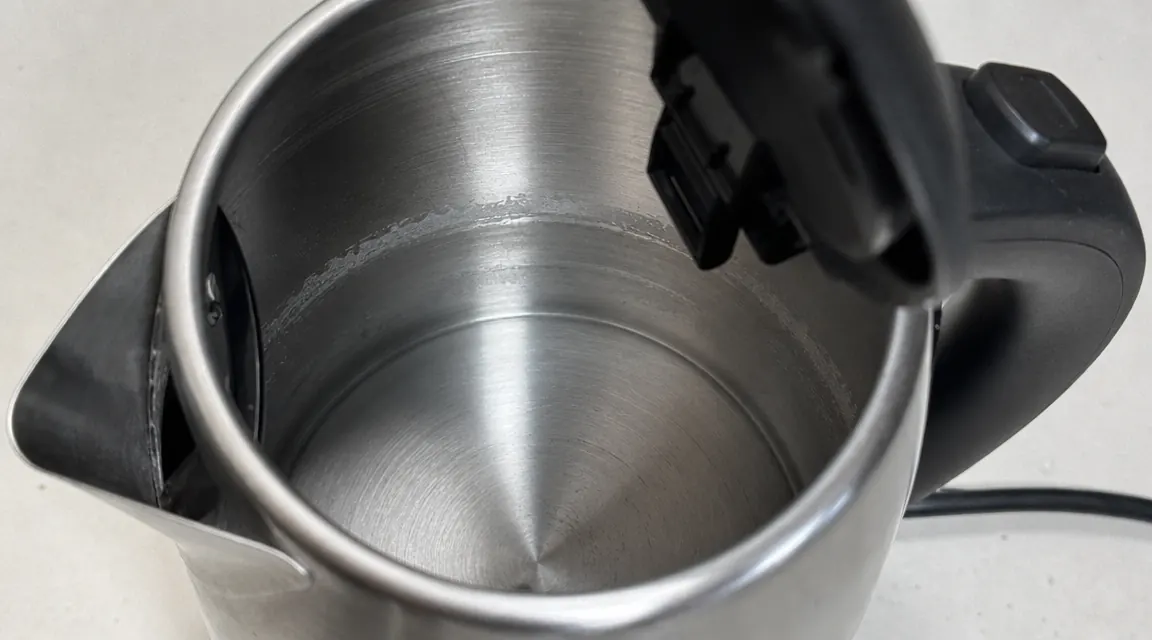 Interior view of electric kettle showing faint mineral staining ring near water line