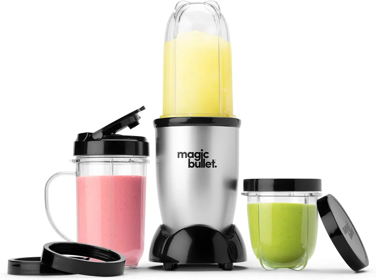 A finished green smoothie in a Magic Bullet to-go cup sitting beside a canvas tote on a kitchen stool
